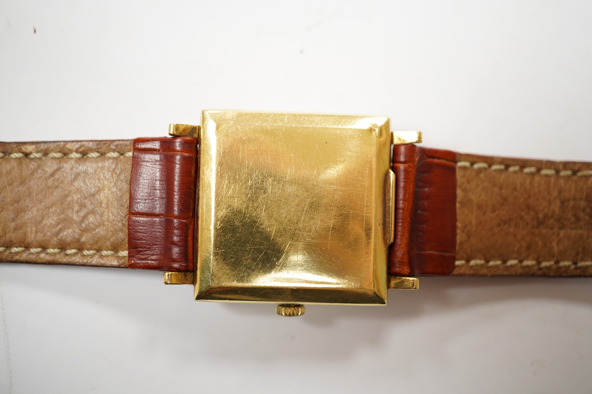 A gentleman's 18k Zenith Automatic square dial wrist watch, with baton numerals and date aperture, on an associated leather strap, case diameter 30mm. Condition - poor.